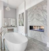 Modern grey marble bathroom renovation with freestanding bathtub.