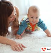 Mother and baby on clean carpet