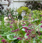 Garden art set in amongst flowers & foliage