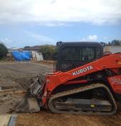 Our tracked skid steer, a versitile all weather machine. We have a range of attachments including pallet forks and a landscape rake.