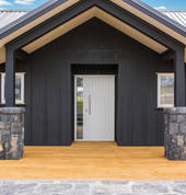 Country home with a welcoming portico and stunning stonework