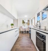Modern kitchen renovation with custom cabinetry and sleek finishes.