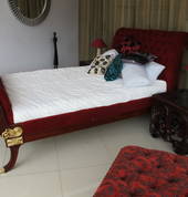 Daybed, side table and foot stool. Buttoned upholstery, fine carving with gilt trim ... an exotic setting or a statement piece.